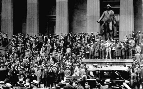People gather across the street from the New York Stock Exchange in New York Oct. 24, 1929. Thousands of investors lost their savings in the worst stock market crash in Wall Street history five days later.