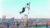 [Fred Grzybowski, an extreme pogo athlete, performs tricks during a promotional appearance in Pittsburgh.]