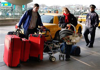 Image: Travelers get out of a cab at LaGuardia Airport